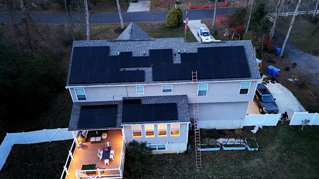 Aerial view of a home with a full solar panel array on the roof